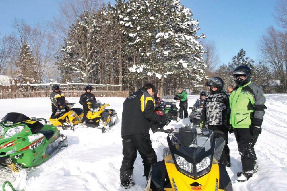 Snowmobilers preparing to ride