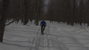 background image of fat tire rider on winter trail