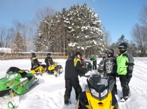 group of snowmobilers on the Manistee county Trail network in winter