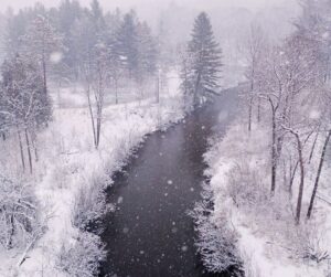 snow falling on river