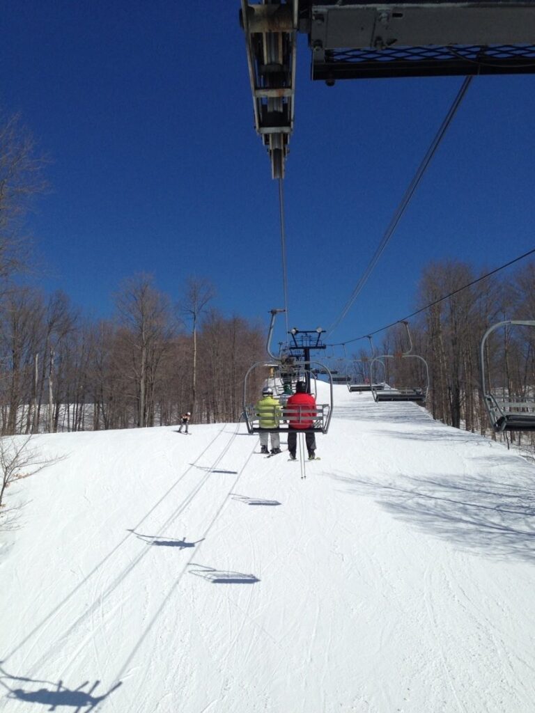 Skiers on lift at Caberfae