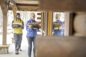 People carrying wood into warming shed at Big M