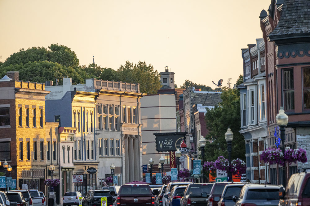 Downtown Manistee, Michigan at dusk. Manistee Princess coming into port by First Street Beach
