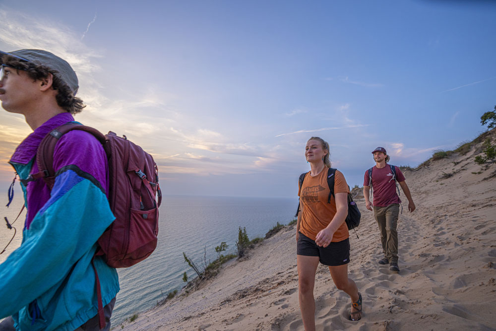 Hiking to and on the Baldy Dune at Arcadia Dunes nature preserve. People hiking the dune of Old Baldy