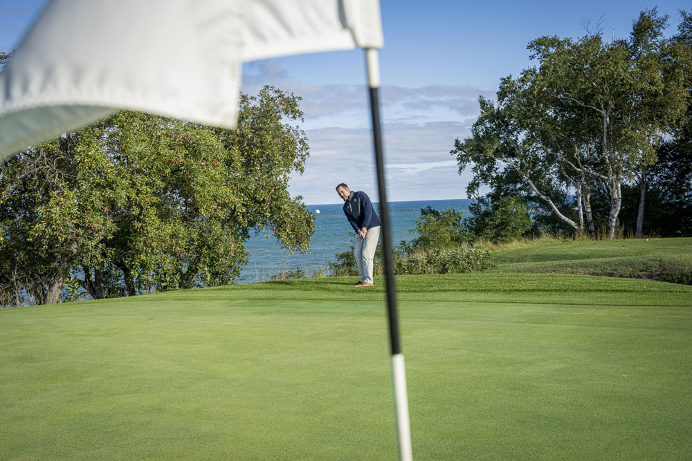 Golfing at Manistee Golf and Country Club. Man golfing