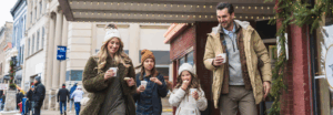 Family walking in front of Vogue Theater in winter